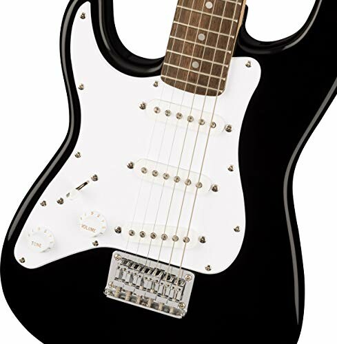 Closeup of a black electric guitar body with white pickguard.