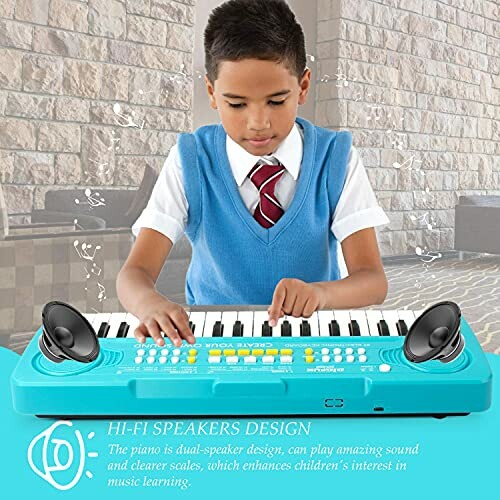 Child playing a blue electronic keyboard with speakers.
