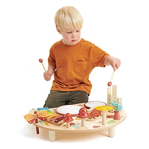 Child playing with a wooden percussion instrument set.
