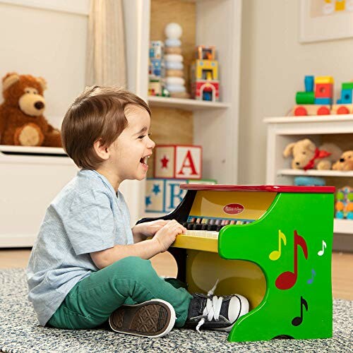Child playing a colorful toy piano in a playroom