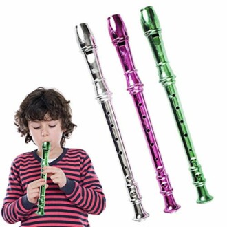Child playing a silver recorder with additional pink and green recorders.