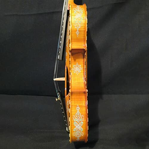 Side view of a decorative violin with intricate white designs.