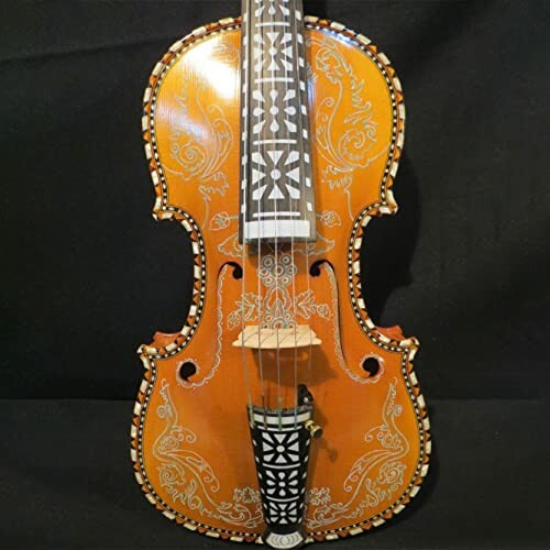 Decoratively carved violin with intricate patterns.