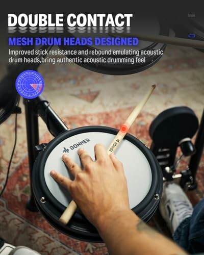 Person's hand holding drumsticks on a mesh drum pad.