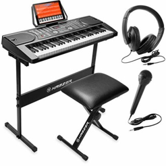 Electronic keyboard with stand, headphones, and microphone.