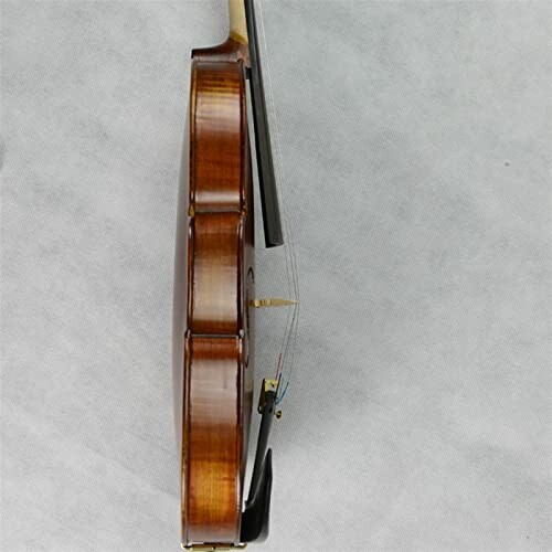 Side view of a violin against a gray background