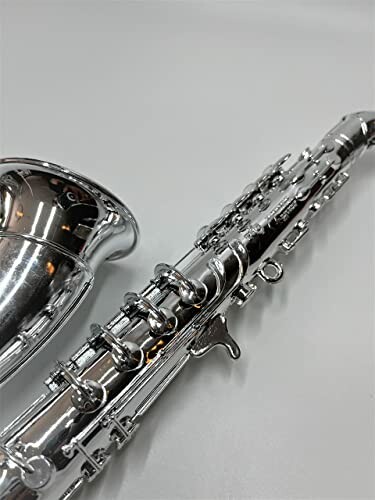 Close-up of a silver clarinet on a gray background