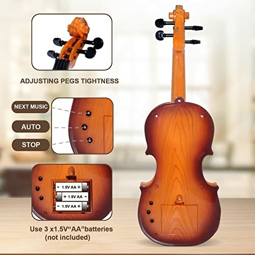 Back view of a toy violin with battery compartment and instructions.